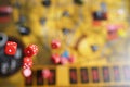 Several rolling red dice fall on a table with boardgame. Gameplay moments Royalty Free Stock Photo