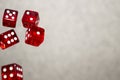 Several rolling red dice fall on a table with boardgame. Gameplay moments Royalty Free Stock Photo