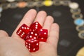 Several rolling red dice fall on a table with boardgame. Gameplay moments Royalty Free Stock Photo