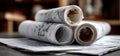 Several rolls of blueprints are resting on a wooden table surface Royalty Free Stock Photo
