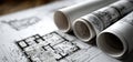 Several rolls of blueprints are resting on a wooden table surface Royalty Free Stock Photo