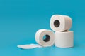 Several rolls of toilet paper lying on blue background. Copy space Royalty Free Stock Photo