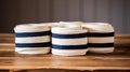 several rolls of white and blue striped fabric on a wooden table top with a black and white stripe on the top of each roll of the Royalty Free Stock Photo