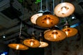 Several round pendant retro loft style lanterns with edison bulbs.