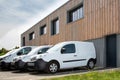 Several row of white service cars vans and industrial vehicle trucks parked in parking lot Transport industry