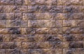 Several rows of beautiful relief facade tiles of dark brown color with streaks