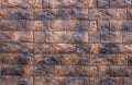 Several rows of beautiful relief facade tiles of dark brown color with streaks