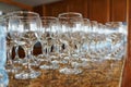 Several rows clear transparent, clean glasses for wine and champagne on counter prepared for drinks. Royalty Free Stock Photo