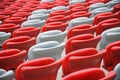 Several rows of red and white stadium seats