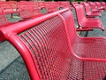 Several rows of seats with red metal chairs