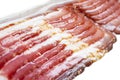 Several rows of sliced smoked bacon isolated on white background. Fresh sliced bacon isolated over white background. Raw dry-cured Royalty Free Stock Photo