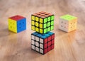 Madrid, Spain; 9 february 2019: Several Rubik cubes intelligence toys solved, in a wood table