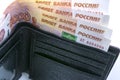 Several Russian banknotes in 5000 rubles inserted in a man`s purse