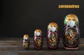 Several Russian matryoshka in a medical mask on a black , coronavirus