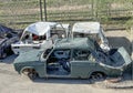 several rusting cars after accidents without wheels without windows in a landfill