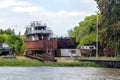 Rusty ships under repair or abandoned on the banks of the tiger river in Argentina