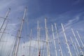 Several sail boat masts against blue sky