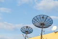 Several satellite dish installed on the house roof with blue sky Royalty Free Stock Photo