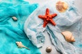 Seashells and starfish on cian and white cloth