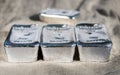 Several silver bars against the background of the texture of coarse cloth.