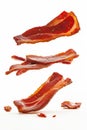 Crispy fried bacon slices falling on white background Royalty Free Stock Photo
