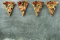 Several slices of pizza on a green background with copy space Royalty Free Stock Photo