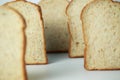 Several slices of sliced bread were arranged in a row on the back, with a focus point on the slice of bread in the middle. on a Royalty Free Stock Photo