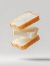 Several slices of sourdough bread float in a surreal manner, emphasizing their texture and form in a clean, neutral setting Royalty Free Stock Photo