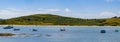 Several small boats are anchored in Clonakilty Bay on a sunny day. Blue sky with white clouds over the beautiful Irish coast. boat Royalty Free Stock Photo