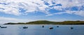 Several small boats are anchored in Clonakilty Bay on a sunny summer. Blue sky with white Royalty Free Stock Photo