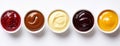 Several small bowls containing different sauces and condiments, presented on a see-through background. Royalty Free Stock Photo