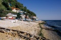 Several small fishing boats lie on the pebble beach of a colorful fishing village of Kavarna, Bulgaria, with a view of the Royalty Free Stock Photo