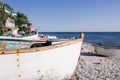 Several small fishing boats on the pebble beach of a colorful fishing village of Kavarna, Bulgaria, with a view of the turquoise Royalty Free Stock Photo