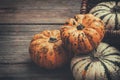 Several small pumpkins on a wooden board