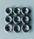 Several small stainless steel flanges are neatly organized in grid pattern, showcasing their shiny surfaces and precise design. Royalty Free Stock Photo