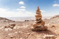Several small stones placed one on another standing in a park of stones in the Judean Desert near the city of Mitzpe Ramon in Isra