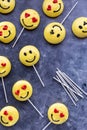 Several smiley face emoji merengue cookies with lollipop sticks. Royalty Free Stock Photo