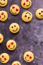 Several smiley face emoticon merengue cookies scattered around with copy space. Royalty Free Stock Photo