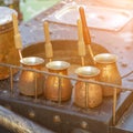 Several smoked pots for making Turkish coffee are stand on a metal table Royalty Free Stock Photo