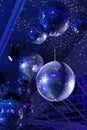 Several sparkling disco balls rotate with flashing lights during a music group performance or dance party. The party Royalty Free Stock Photo