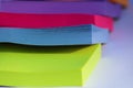 Piled bright colored sticky note blocks; green, blue, pink and purple Royalty Free Stock Photo
