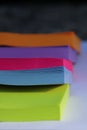 Piled bright colored sticky note blocks; green, blue, pink and purple Royalty Free Stock Photo