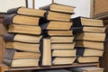 Several stacks of large old books lying on the table Royalty Free Stock Photo