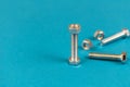 Several steel bolts and nuts on a blue background. Close-up Royalty Free Stock Photo