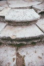 Several steps of an old and ruined vintage staircase made of white stone Royalty Free Stock Photo