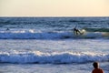 Several surfers riding the waves while a young boy watches, La Jolla Beach, San Diego, CA, 2016