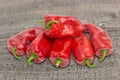 Several sweet red Kapia peppers on wooden surface Royalty Free Stock Photo