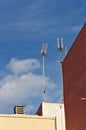 Several television antennas on roofs of some buildings Royalty Free Stock Photo