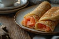 Several thin pancakes stuffed with salted salmon, close up grey plate on rustic style wooden tableware, treats for Royalty Free Stock Photo
