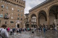 Florence ITALY - August 5, 2023 - Tourists in Piazza della Signoria next to the Loggia dei Lanzi and the Vecchio palace Royalty Free Stock Photo